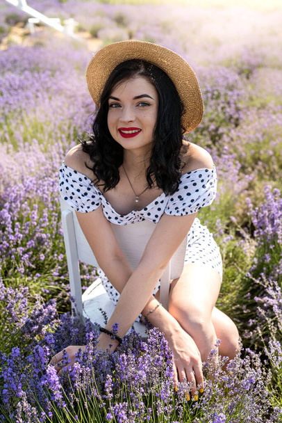 Attractive woman with fashion makeup posing on lavender field - 写真・画像