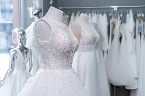 Beautiful wedding bridal dresses on mannequin in showroom in mall - Photo, image