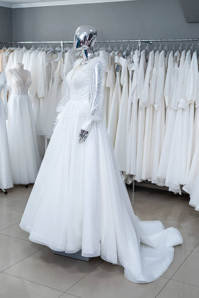 Beautiful wedding bridal dresses on mannequin in showroom in mall - Photo, image