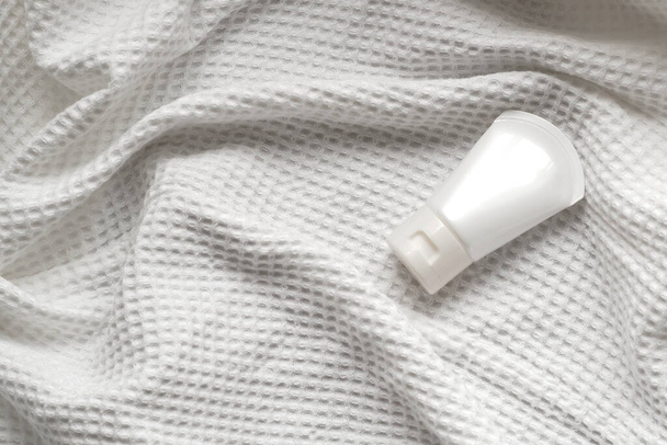 lotion tube mockup isolated on white fabric background. - Фото, изображение