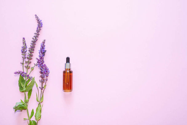 Flat lay composition with lavender flowers and natural cosmetics on a pink background. View from above - Foto, Bild
