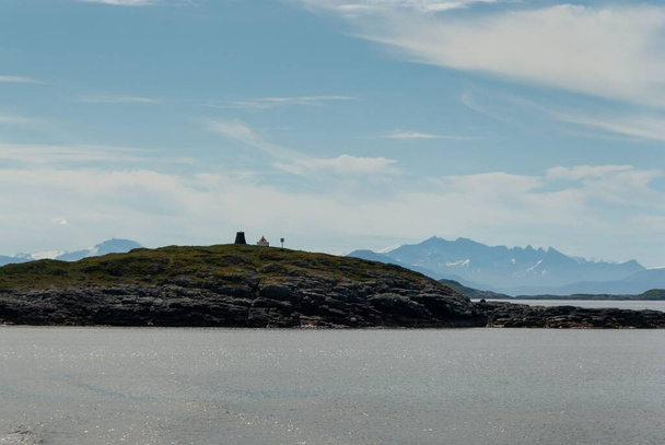 The distant lighthouse on the shore of Lofoten Island in Norway - Foto, immagini