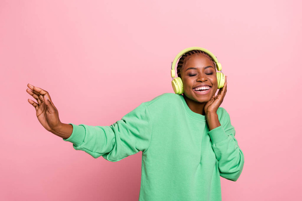 Photo of funky overjoyed girl closed eyes enjoy listen favorite single isolated on pink color background. - Foto, immagini