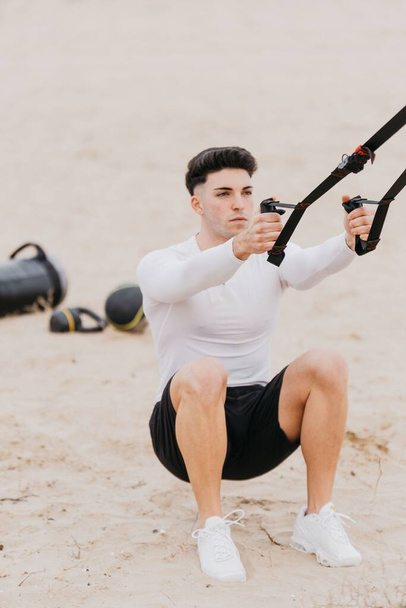 A vertical shot of a Spanish man exercising near the beach - Zdjęcie, obraz