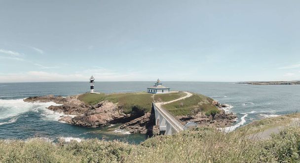 Nice view of the lighthouse of the town of Ribadeo during the day, as one of the most touristic natural environments - Foto, Bild