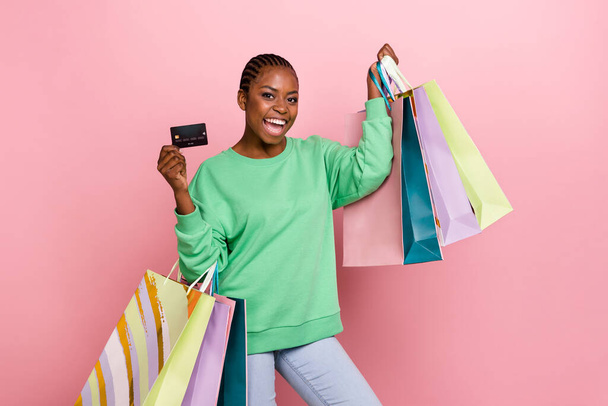 Photo of funny positive lady hold packages debit plastic card isolated on pink color background. - Φωτογραφία, εικόνα