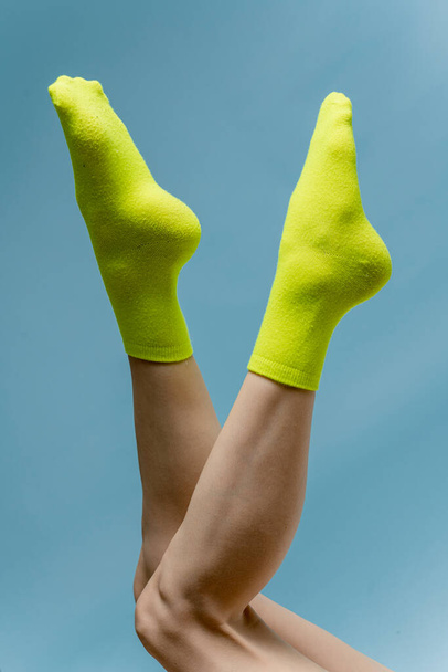 studio shot of woman legs in bright socks - Foto, imagen