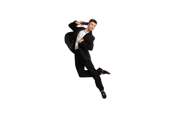 Interview. Creative portrait of young office worker in business suit in action isolated over white background. Finance, aspiration, business, job concept. copyspace for ad - Фото, зображення