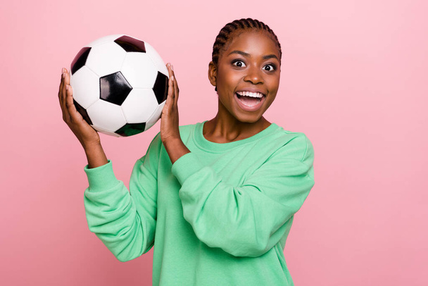 Photo of crazy funky girl hold football toothy smile look camera isolated on pink color background. - Φωτογραφία, εικόνα