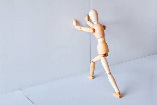 Wooden figure showing a position of stretching muscles to exercise - Photo, image