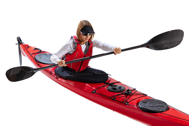 water sport activities. Young woman, sportsman in red canoe, kayak with a life vest and a paddle isolated on white background. Concept of sport, nature, travel, active lifestyle - Foto, immagini