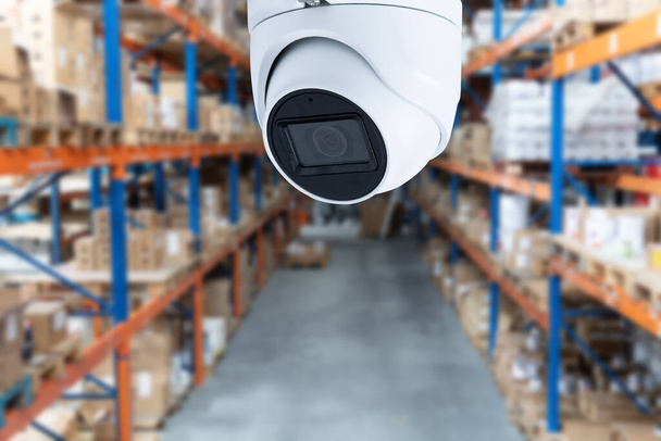 Video surveillance at an industrial enterprise. The video camera captures what is happening in the room around the clock. Installation of a video surveillance system in a warehouse. - Photo, Image