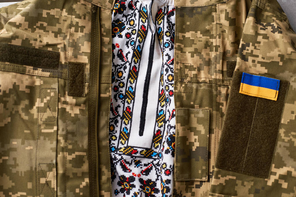 Ukraine traditional clothes and military uniform of ukrainian soldier. Armed Forces of Ukraine with spirit of freedom. Defend our country - 写真・画像