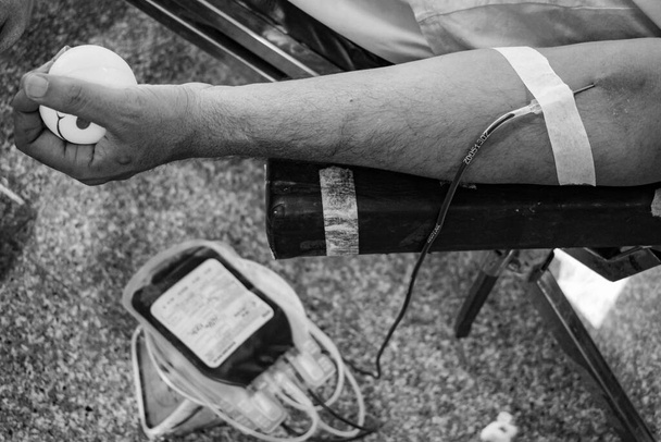 Донор крови в лагере для сдачи крови проводится с надувным мячом, держащимся за руки в храме Баладжи, Вивек Вихар, Дели, Индия, Изображение для Всемирного дня донора крови 14 июня каждый год, Лагерь сдачи крови - Фото, изображение