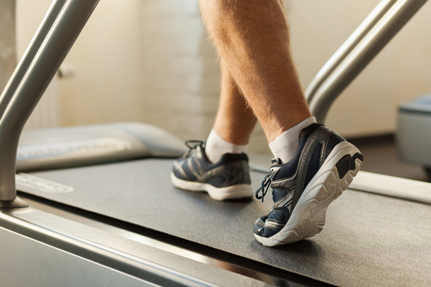 Man walking by treadmill - Φωτογραφία, εικόνα