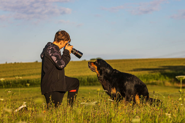 boy and hovie, two friends, photographer taking a close up of a dog - Fotó, kép
