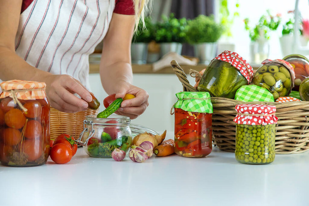 Woman jar preserve vegetables in the kitchen. Selective focus. Food. - Zdjęcie, obraz