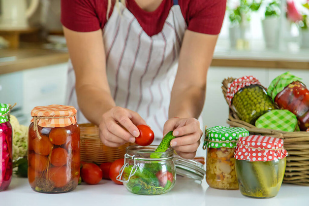 Woman jar preserve vegetables in the kitchen. Selective focus. Food. - Foto, Imagen