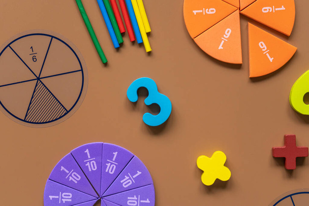 Set of supplies for mathematics and for school. Fractions, rulers, pencils, notepad on brown background,  Back to school, fun education concept - Foto, Imagem