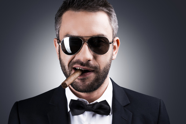 Man in formalwear and sunglasses smoking cigar - 写真・画像