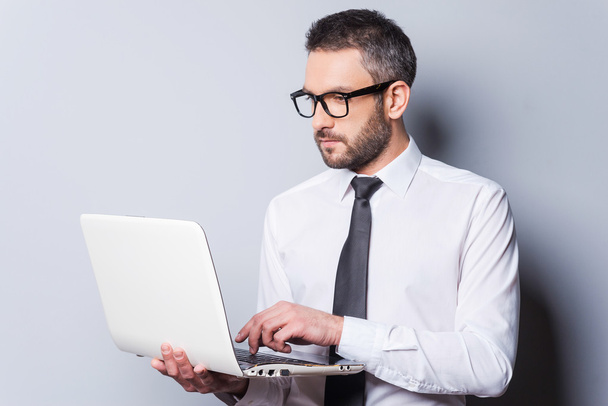 Man in shirt and tie working on laptop - Фото, зображення