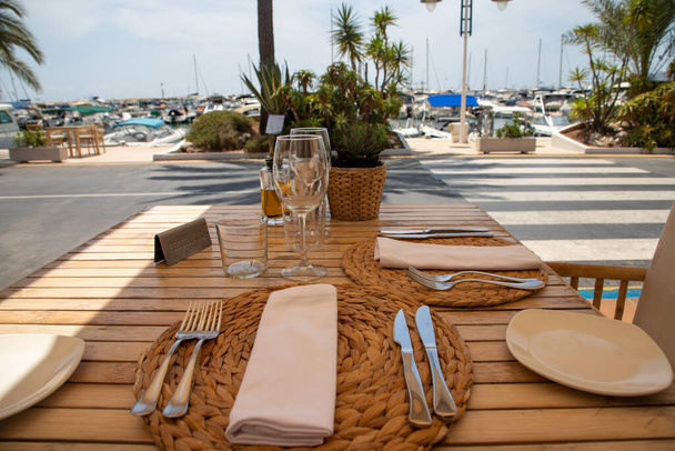 Reserved restaurant table in the port, laid table, with a view o - Photo, image