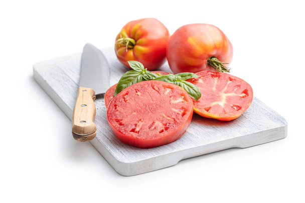 Sliced bull heart tomatoes on cutting board isolated on a white background. - Foto, Imagem