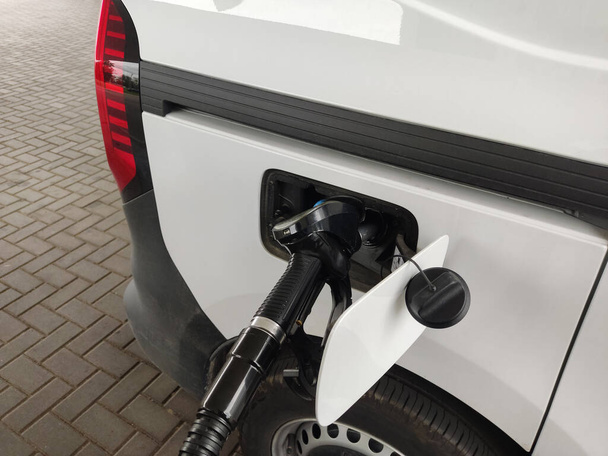 The car refuels in the gas tank. Car refueling close-up. - Foto, afbeelding