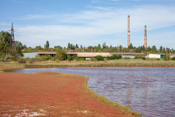 Technical settler of industrial water of mining industry in Kryvyi Rih, Ukraine. Redwater is polluted with iron ore waste. Discharge of process water in the sump after the iron ore beneficiation - Фото, зображення