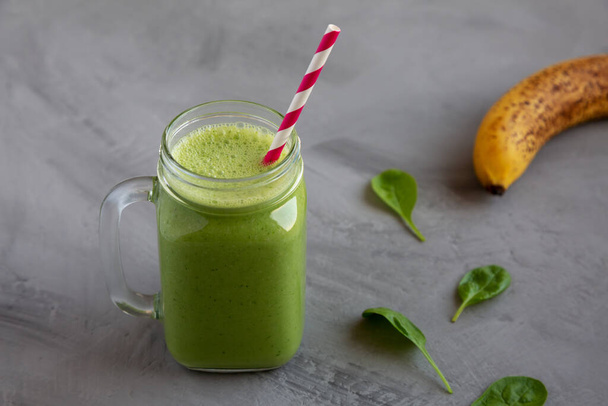 Homemade Greek Yogurt Green Smoothie with Spinach and Banana in a Jar, side view.  - 写真・画像