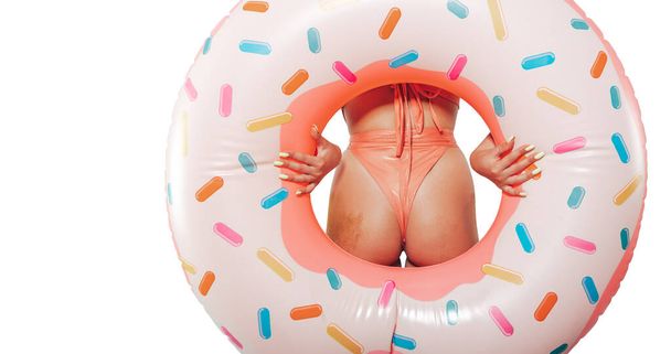Woman with inflatable donut ready for the summer isolated on white background - Фото, зображення