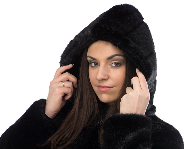 Image smiling brunette in fake fur coat with hood - Фото, зображення