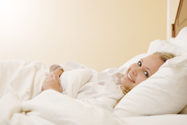 Peaceful Woman Lying in Bed Resting at Home - Foto, imagen