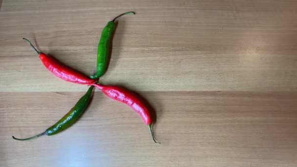 Peppers over a brown wooden table. Background with copy space. - Séquence, vidéo
