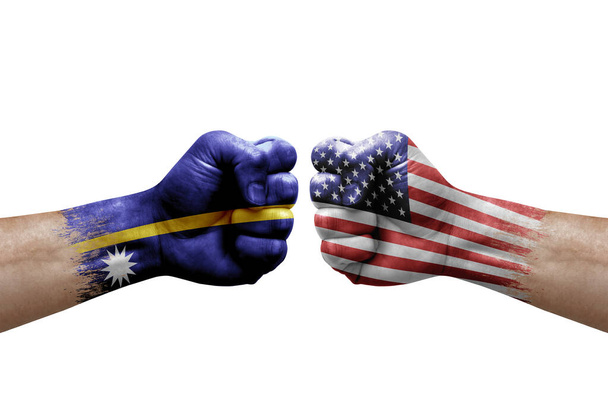 Two hands punch to each others on white background. Country flags painted fists, conflict crisis concept between nauru and usa - Valokuva, kuva