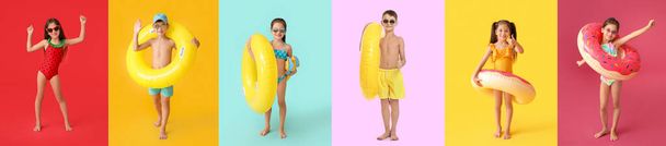 Group of cute little children in swimsuits, with inflatable rings and snorkeling paddles on color background - Foto, Bild