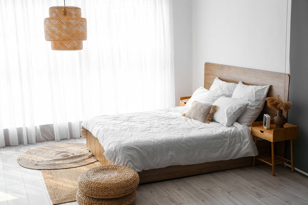 Interior of cozy bedroom with rattan poufs - 写真・画像