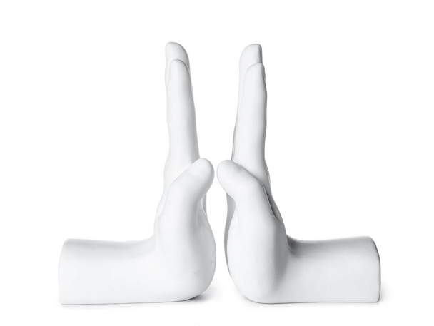 Bookend in shape of hands on white background - 写真・画像
