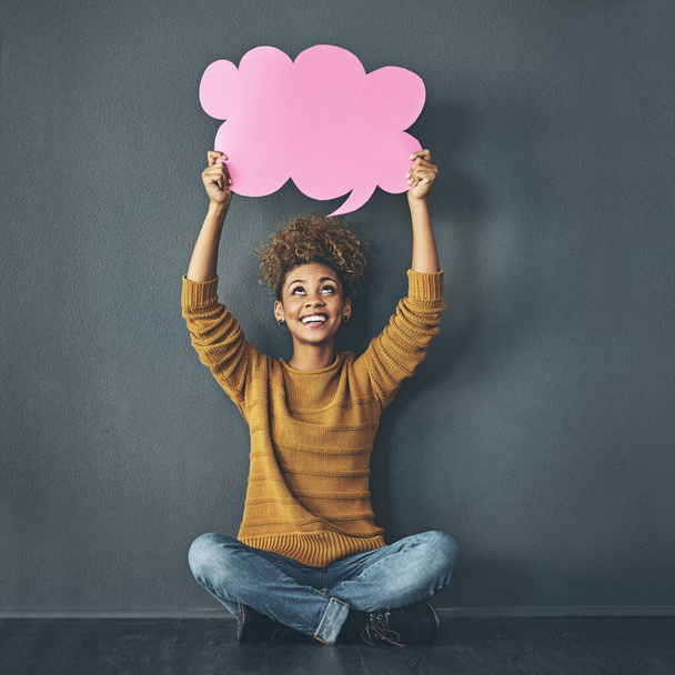 Woman holding thought bubble, chat and speech board for voice opinion, chatting on social media and showing idea. Smiling excited creative thinking of promotion strategy, plan or innovating vision. - 写真・画像