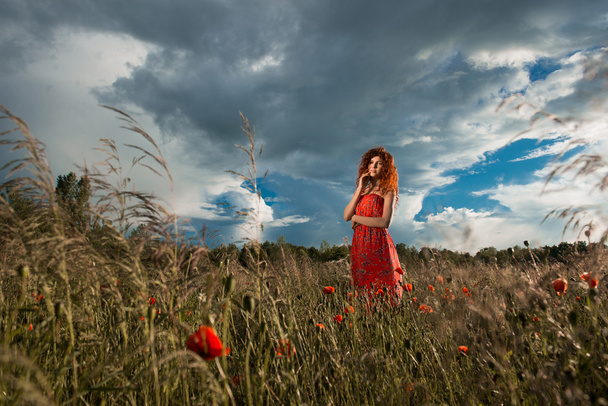 Beautiful air woman in the green field at sunset - Photo, Image