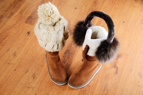 winter boots, hat and fur headphones on the floor horizontal - Photo, Image