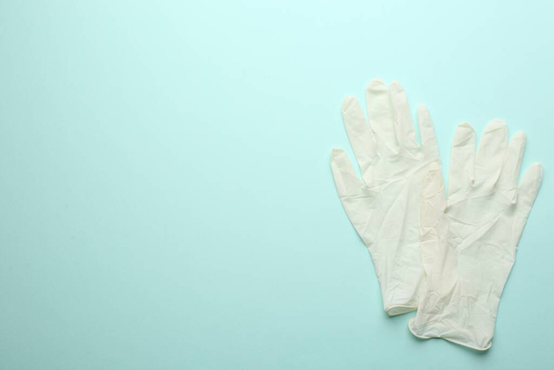 Pair of medical gloves on light blue background, flat lay. Space for text - Фото, зображення