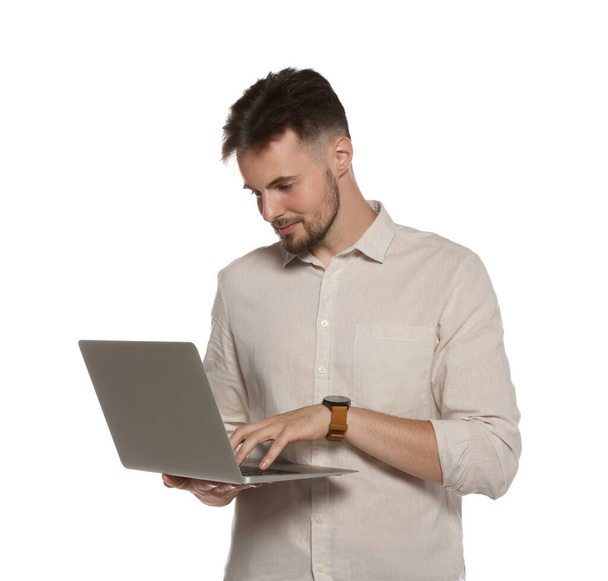 Handsome man working with laptop on white background - Zdjęcie, obraz