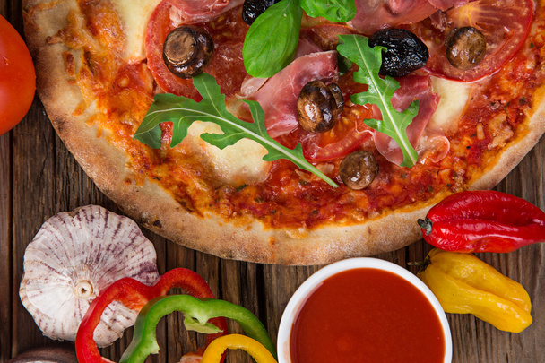 Delicious italian pizza served on wooden table - Foto, Imagen