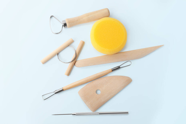 Set of clay modeling tools on light blue background, flat lay - 写真・画像