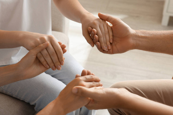 Group of religious people holding hands and praying together indoors, closeup - Foto, imagen