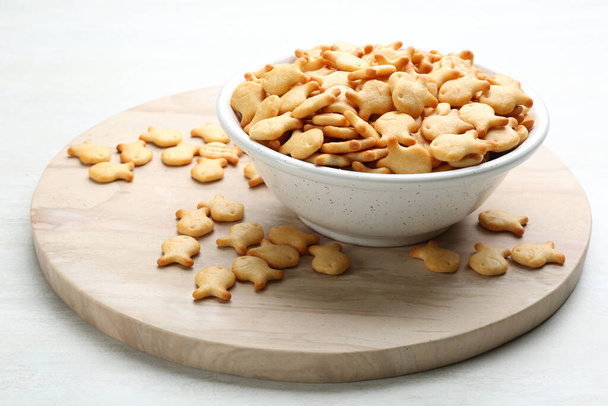 Delicious goldfish crackers in bowl on table - Valokuva, kuva