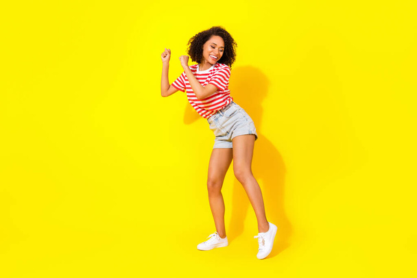 Full size photo of young dancing funny woman after work chill vacation dance club isolated on yellow color background. - Fotoğraf, Görsel