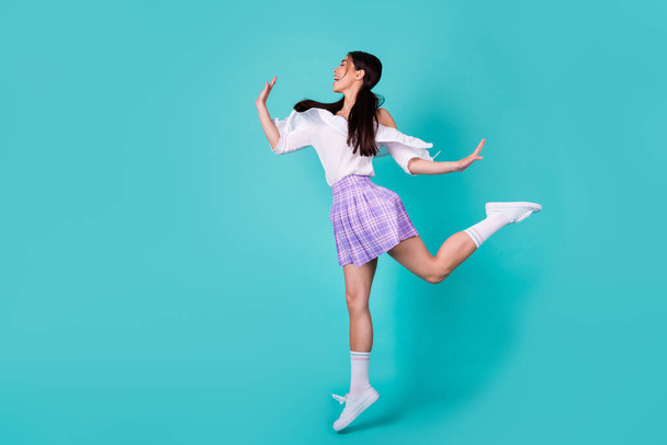 Full body portrait of lovely energetic filipino person jumping rejoice isolated on vibrant cyan color background. - Fotografie, Obrázek
