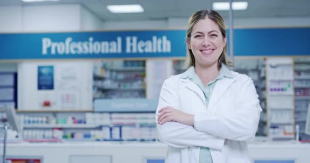 Pharmacist, medical and healthcare professional in pharmacy showing trust, care and ready to help with choosing medicine product. Portrait of smiling, happy and friendly woman in medication drugstore. - Video